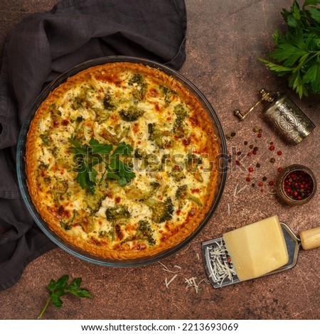 Quiche Lorraine with chicken and broccoli. Pie with vegetables, poultry, cheese, parsley and spices.  Rustic style. Traditional French food. Selective focus, top view, square picture