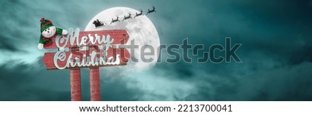 background with a merry christmas banner and santa claus flying in the moonlight - copyspace