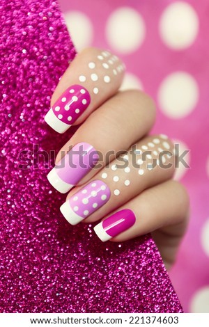 French manicure with pink shades and white dots on a brilliant background.