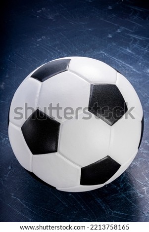 Football ball on black background, Football ball sports equipment on dark wooden background. 