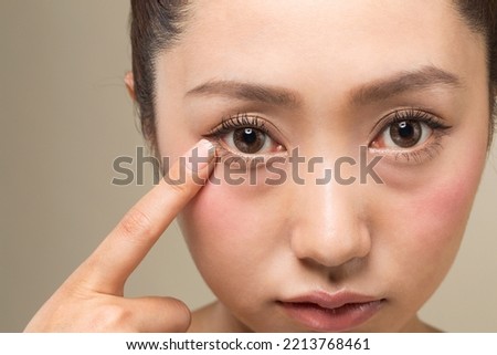 A woman pointing to her eyes. Royalty-Free Stock Photo #2213768461