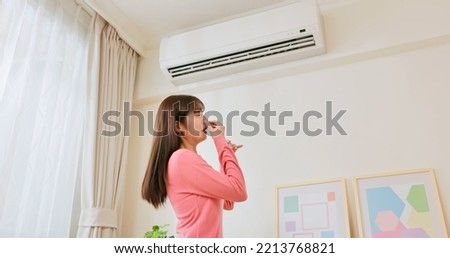 air conditioner or heater odor - asian woman using heating and it has bad smell at home Royalty-Free Stock Photo #2213768821