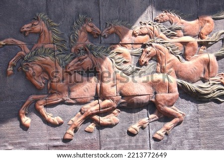 Low bas-relief sandstone slabs depicting 8 horses in the garden for success in the 8 directions.