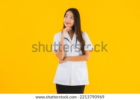 Portrait beautiful young asian doctor woman smile happy work in hospital and clinic on yellow isolated background