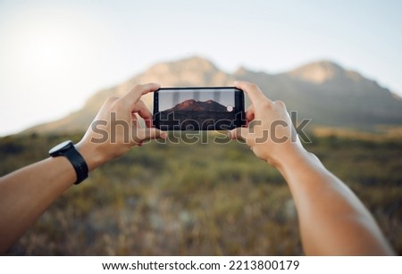 Hands, phone and mountain picture in nature for adventure, travel and countryside in the outdoors. Hand of traveler taking a photo of the natural environment with mobile smartphone in South Africa