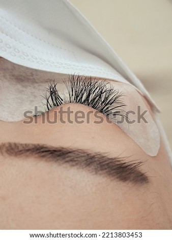 Close up of eyelash Extensions in beauty salon overgrown lashes . High quality photo