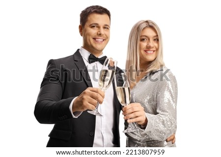 Young man and woman smiling and holding glasses of champagne isolated on white background
