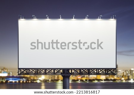 Blank white billboard on cityscape background at evening, front view. Mock up, advertising concept