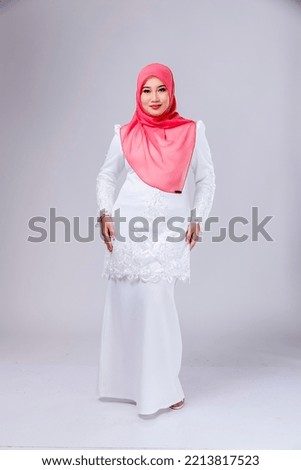 Beautiful asian women in hijab over isolated background. Smiling young asian muslim woman.