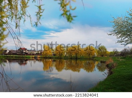    A forest lake surrounded by autumn foliage. Forest lake in autumn. Autumn forest lake nature october.                            
