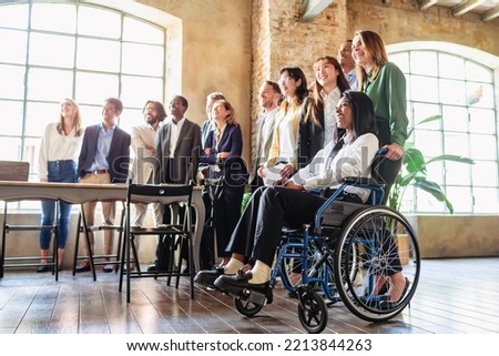 Multiracial businesspeople smiling at the camera in a modern office. Diverse team of businesspeople and inclusivity concept Royalty-Free Stock Photo #2213844263