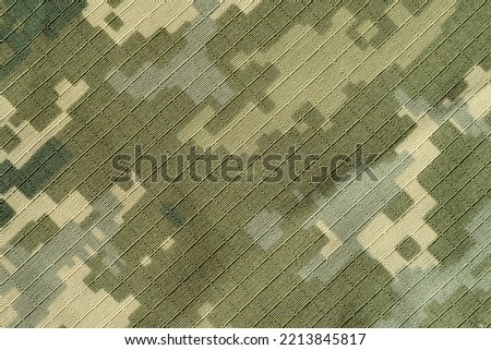 Ukrainian soldier's pixel camouflage uniform diagonal texture.