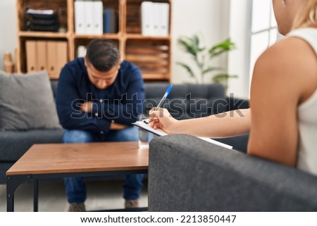 Young latin man patient stressed having psychologist session at psychology clinic