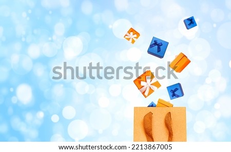 gift boxes fly out of a paper bag on a blue background