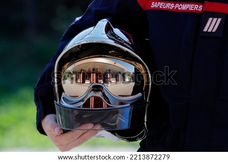 Fire department.  Firefighter and helmet. French Sapeurs Pompiers. France.  Royalty-Free Stock Photo #2213872279