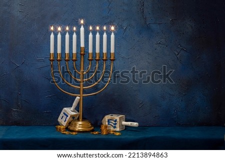 Jewish Hanukkah Menorah 9 Branch Candlestick, dreidel, gold coins. Holiday Candle Holder. Nine-arm candlestick. Traditional Hebrew Festival of Lights candelabra. Background for design with copy space. Royalty-Free Stock Photo #2213894863