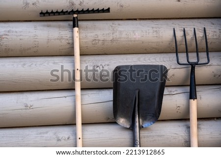 tools for working in the garden on a wooden wall
