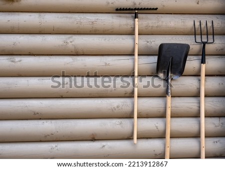 tools for working in the garden on a wooden wall