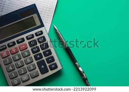 Close-up photo, top corner of calculator and bank book