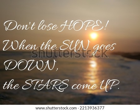 Motivational quote "Don't lose hope! When the sun goes down, the stars come up." on nature background. Beautiful sunset at sea horizon, with sun reflection on the water.