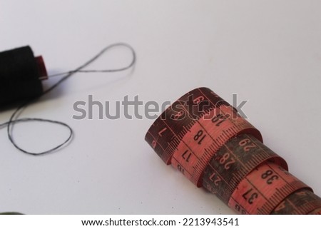 black thread and fabric meter isolated on white