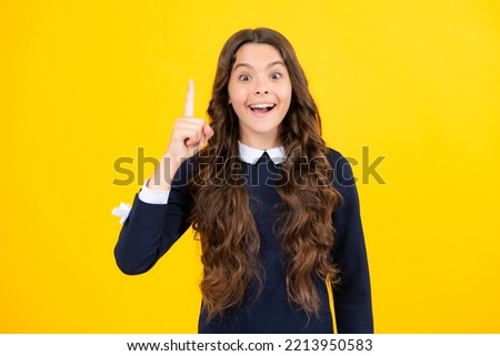 Confident and successful young teenager child over isolated yellow background showing and pointing up with finger number one. Kid have an good idea.