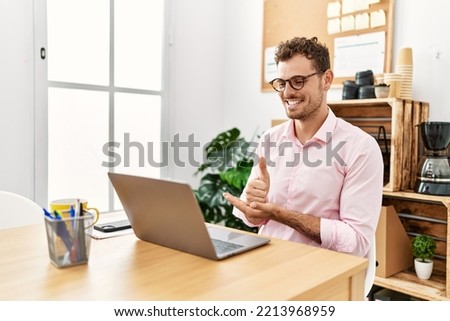 Young hispanic man having video call communicating with deaf sign language at office Royalty-Free Stock Photo #2213968959