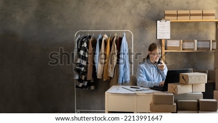 SME business women use laptop computer checking customer order online shipping boxes at home office. Starting Small business entrepreneur SME freelance. Online business concept. Banner