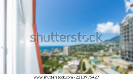 Abstract defocused sea view with clear blur sky, view from high floor of luxury hotel room terrace. Blurred background of beautiful outdoor swimming pool in luxury hotel and resort on a sunny day