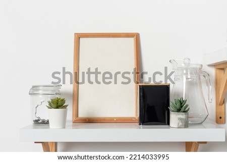 Wooden vertical frame with kitchen decor over white wall. Mockup Template for your design, text.