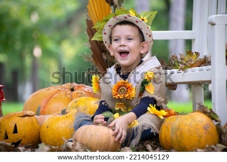 Child enjoying autumn time. Boy in a costume is playing in the park