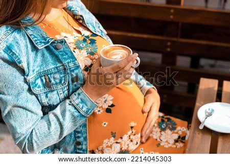 Pregnant coffee drink woman. Happy pregnancy girl drink hot coffee in restaurant. Represent breakfast for energy and freshness concept Royalty-Free Stock Photo #2214045303