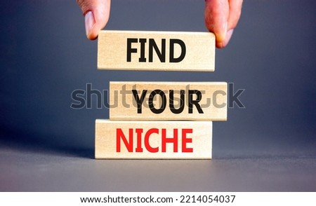 Find your niche symbol. Concept words Find your niche on wooden blocks. Businessman hand. Beautiful grey table grey background. Business and find your niche concept. Copy space.