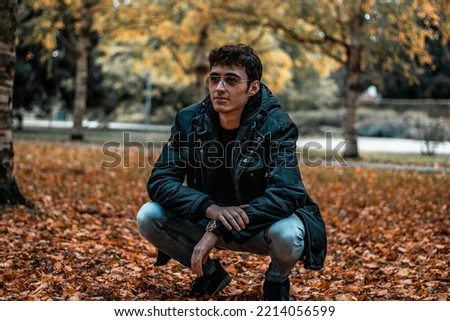 Man modeling in autumn scenery...