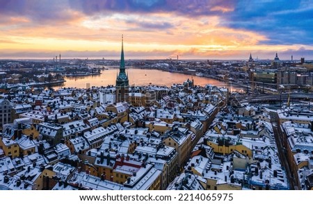 Colorful sunrise over the snowy Gamla stan, Stockholm Sweden Royalty-Free Stock Photo #2214065975