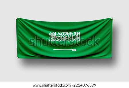 Saudi Arabia flag hangs on wall, white background
