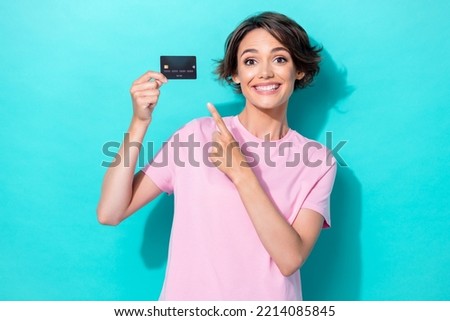 Photo of positive satisfied lady arm finger hold present wireless bank payment plastic card empty space isolated on cyan color background