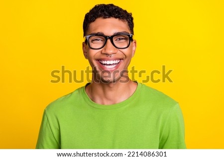 Photo portrait of nice young guy smiling oculist check up dressed trendy green look eyeglasses isolated on yellow color background