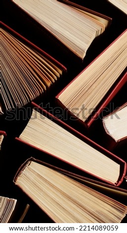 vintage books  background, image of a stack of hard back books on the end of the pages toned 