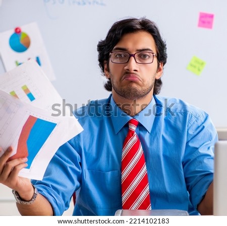 Young male financial manager working in the office