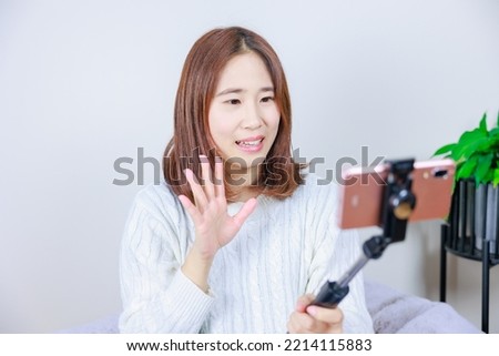 Woman talking on mobile phone using selfie stick