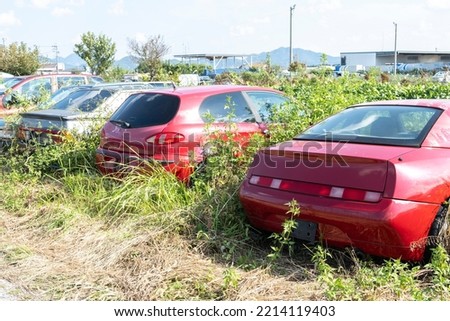 Junk car yard.
Several cars are abandoned in an overgrown lot. Royalty-Free Stock Photo #2214119403