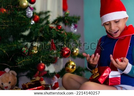 Surprised boy opening christmas present