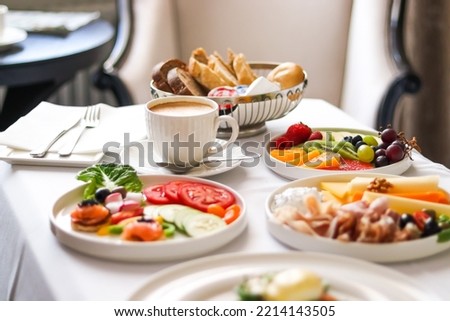 Luxury hotel and five star room service, various food platters, bread and coffee as in-room breakfast for travel and hospitality brand Royalty-Free Stock Photo #2214143505