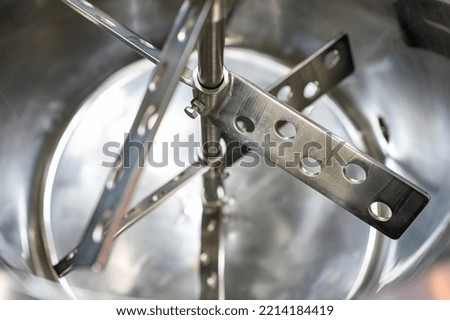 Close up stainless steel stirrer flat beater inside barrel commercial food mixer machine for industrial