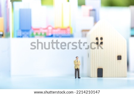 Miniature people: Businessman home on calendar stack of coin with copy space for text using as background saving, investment, money, financial, business analytics concept.