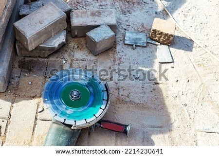 Angle grinder at a construction site. Saw for cutting fittings. Reinforced concrete foundation or grillage