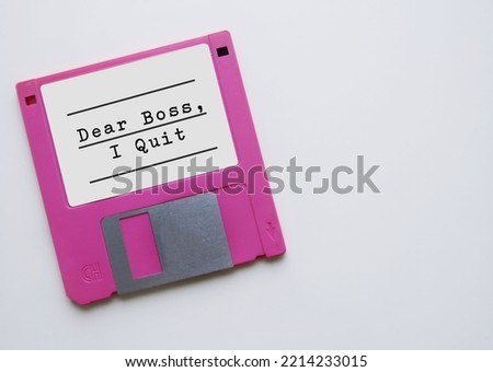 Vintage floppy disk with typed text DEAR BOSS I QUIT, concept of employess making decision to quit their job, escape 9-5 rat race, resign and build their own business Royalty-Free Stock Photo #2214233015