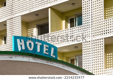 The signboard in front of an abandoned hotel.
