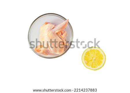 Raw chicken wings in glass bowl isolated on white background with clipping path.